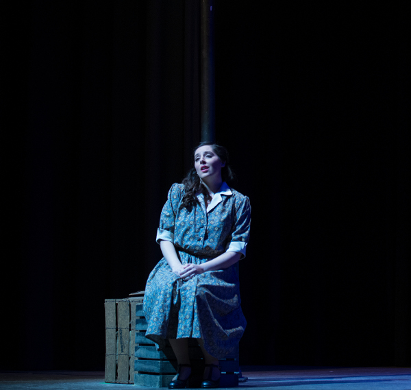 Loyola student Haley Whitney sings under a street lamp in the opera production of Street Scene.