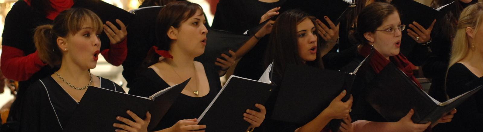 Loyola students singing in the choir at holy name