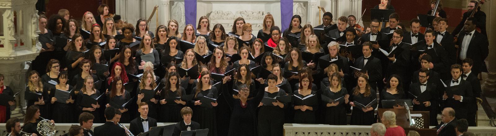 Dr. Meg Frazier conducts the Loyola Chorale in Holy Name of Jesus Church.