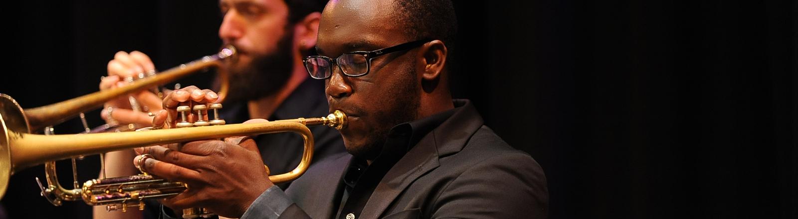 Two students playing jazz on trumpets in a concert 