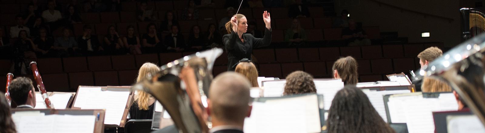 Dr. Serena Weren conducts the Loyola Wind Ensemble in Roussel Hall.